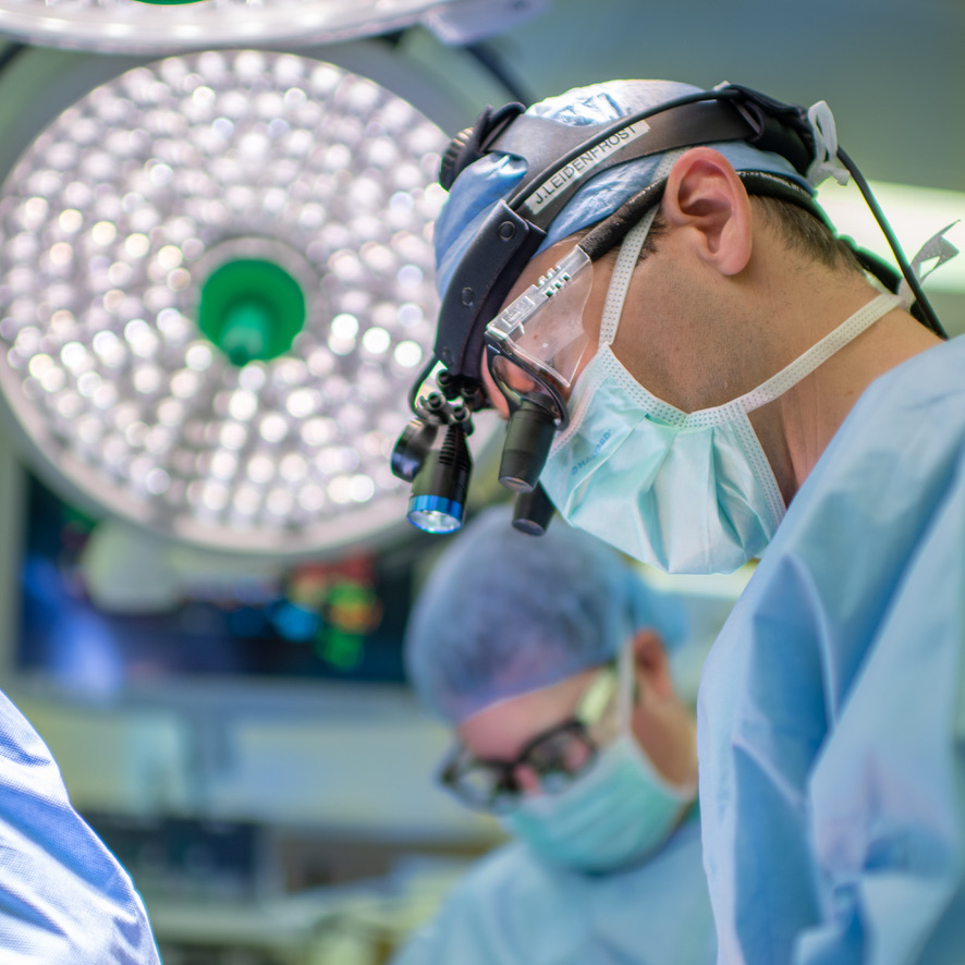 Dr. Leidenfrost in the operating room, his name on his headlight band